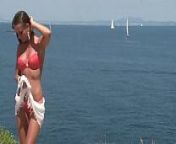Chick in bikini strips by cliff from bikinistreifen