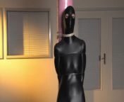 Spandex zentai babe with fishing line tied to concrete post from encasment bondage