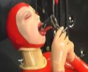 Sexy girl encased in red rubber catsuit loves medical games with mouth spreader and nipple clamps from sexy maid with mouth spreader is fucked hard on the kitchen counter