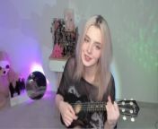 Hot blonde girl playing on ukulele and singing in naughty outfit from cute apron lookbook 2023 outfit